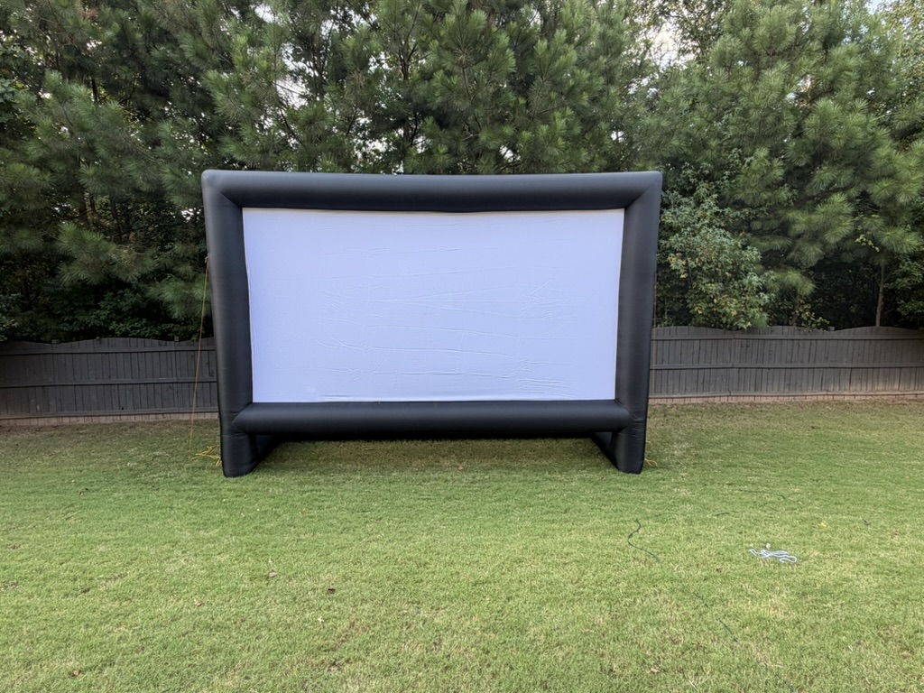 Giant outdoor inflatable movie screen set up in a private backyard