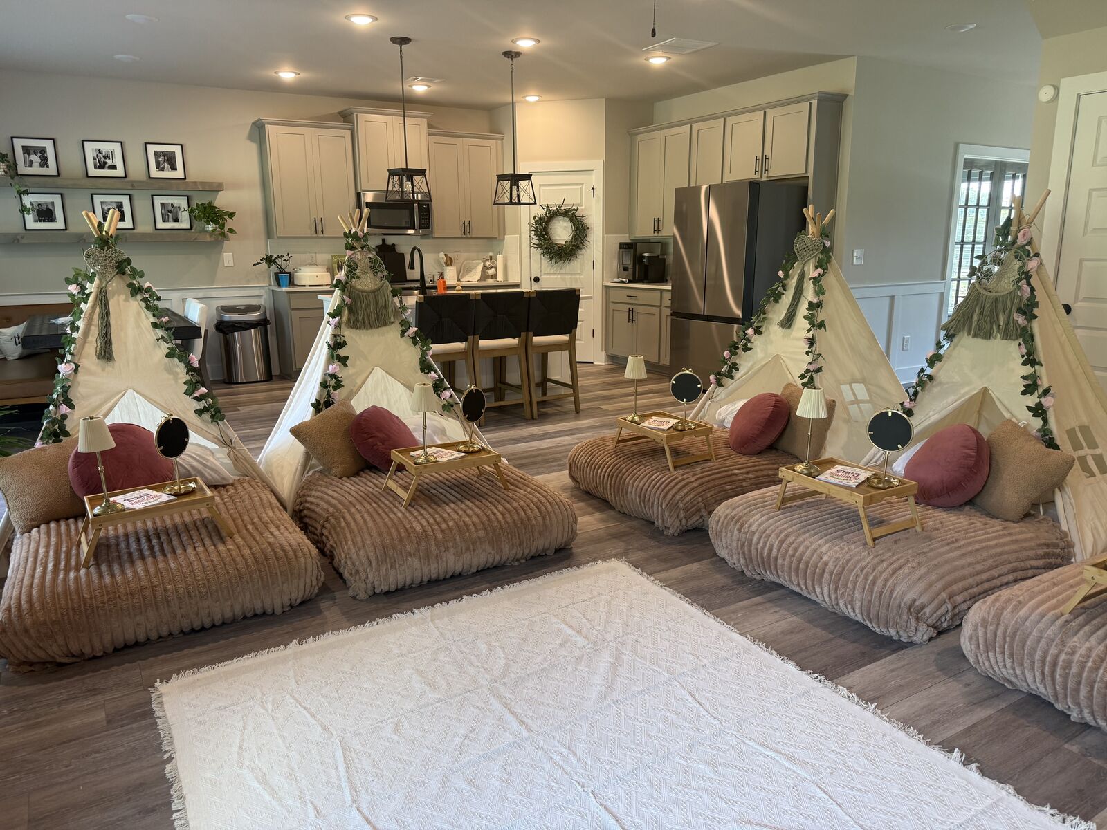 Six blush-and-botanical teepees arranged across a bright living room