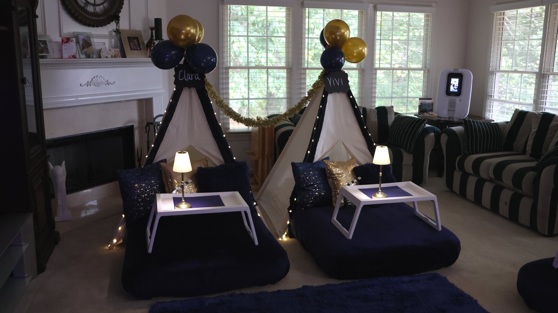 The same living room transformed with a navy-and-gold teepee setup and karaoke booth