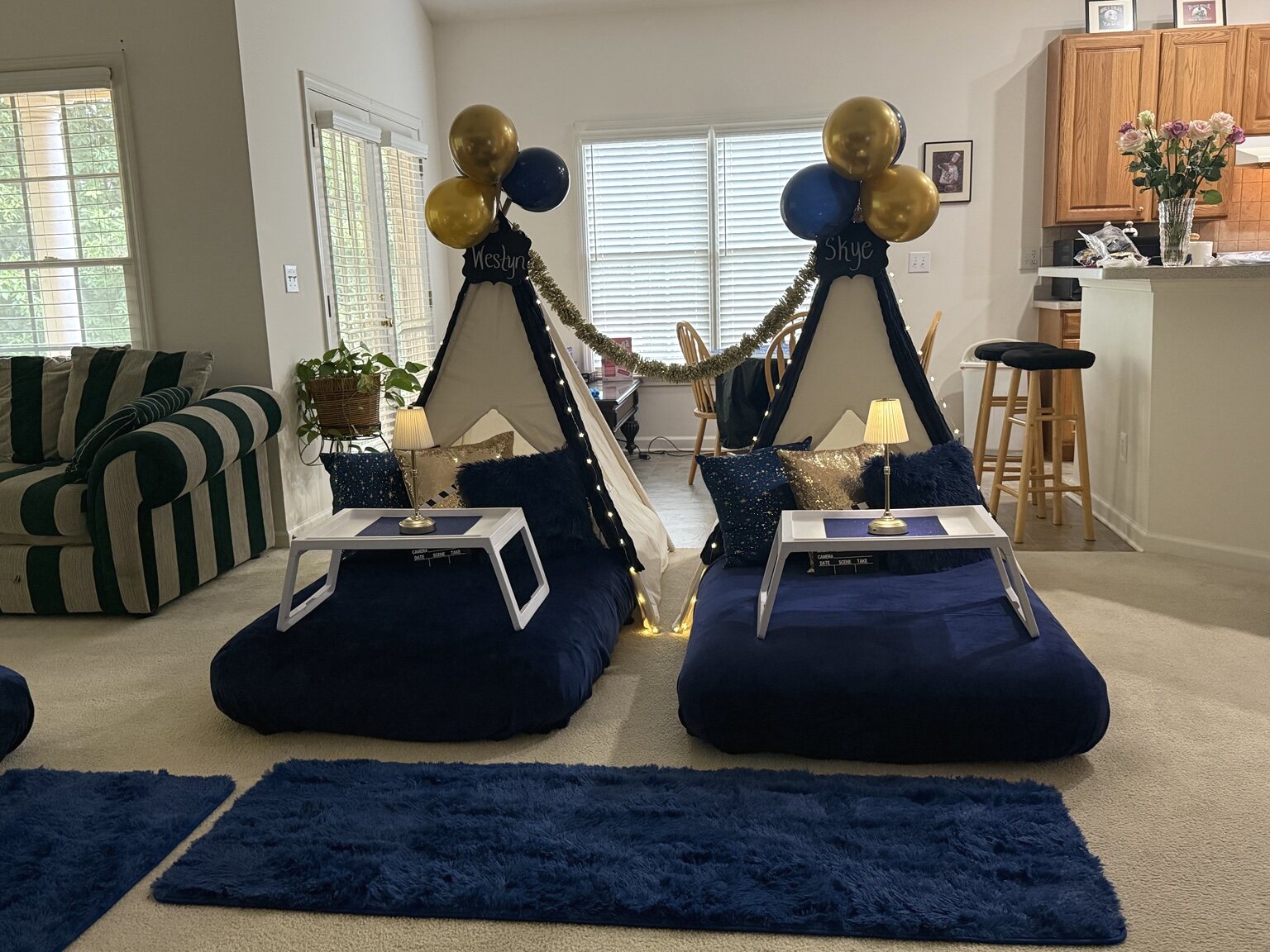 Navy-and-gold teepees styled beside the living room and kitchen