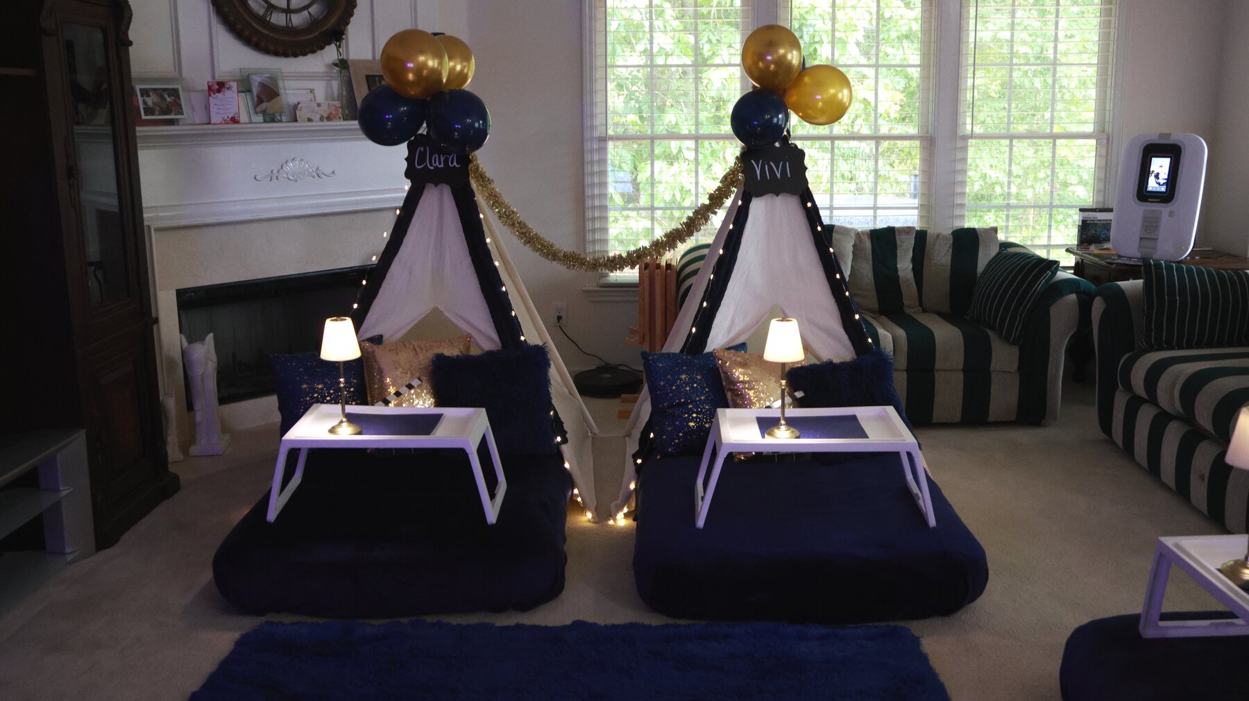 Wide navy-and-gold teepee party setup with illuminated teepees and a karaoke booth
